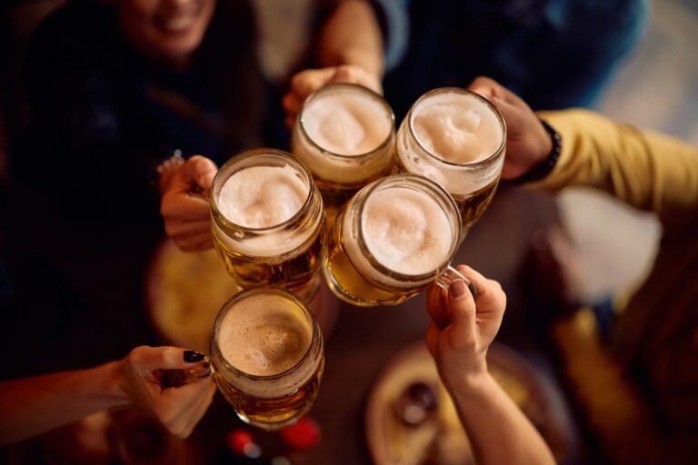 Close,Up,Of,People,Toasting,With,Beer,Glasses.